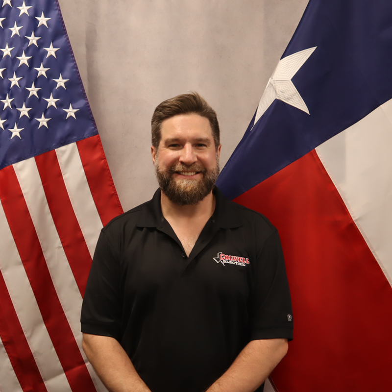 a man standing in front of a flag