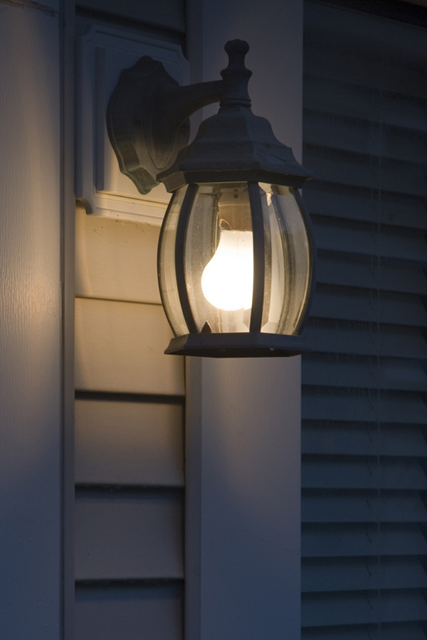 a lamp hanging from the side of a building