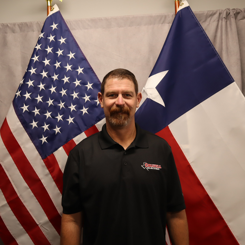 a man standing in front of a flag