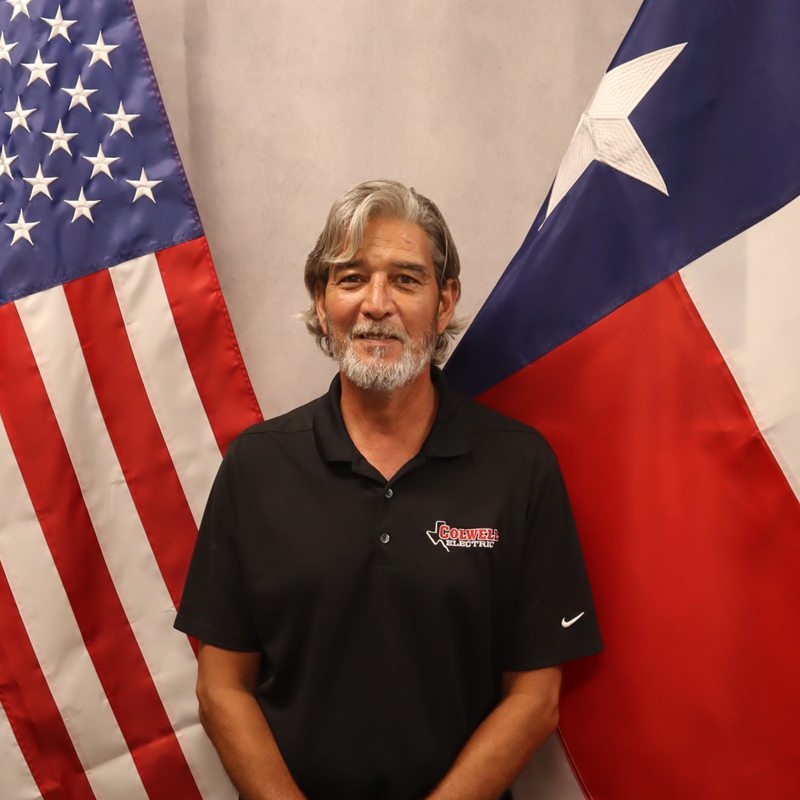 a man standing in front of a flag